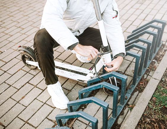 Persona quitando el candado de un patinete eléctrico